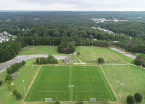 An aerial view of the Braly Soccer Complex, showing multiple synthetic turf soccer fields.