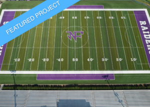 The North Forsyth High School football field, featuring the Raiders logo on the new synthetic turf.