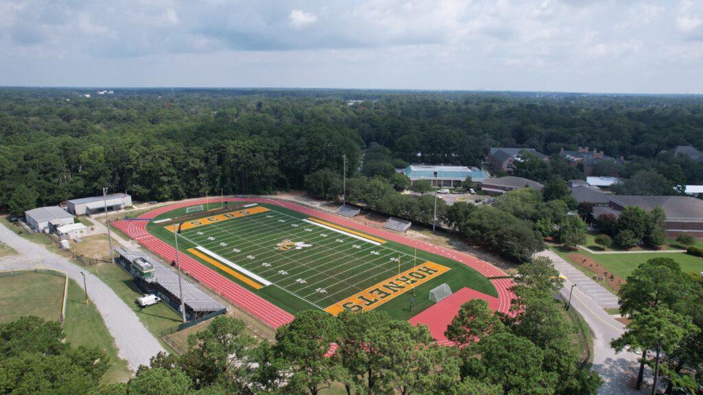 A high, wide Savannah campus reveal that demonstrates the field’s place within the school community.