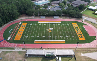 A balanced finished-field aerial that clearly shows the Hornets branding, full stadium context, and field quality.