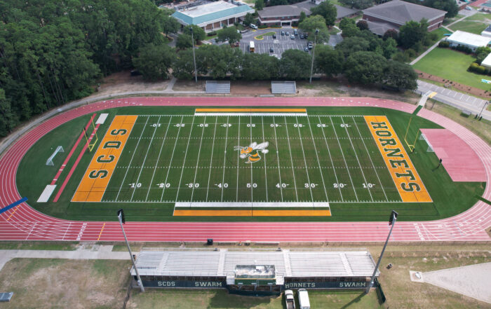 A balanced finished-field aerial that clearly shows the Hornets branding, full stadium context, and field quality.